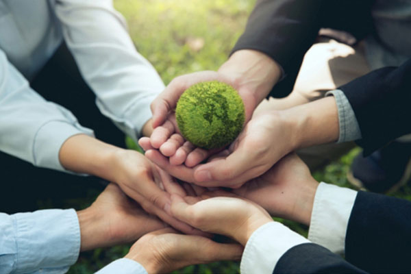 Employees holding globe